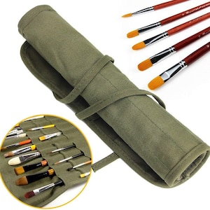 May include: An olive green canvas brush roll with a tie closure, partially unrolled to reveal various paint brushes. Several paint brushes with wooden handles and orange bristles are displayed. The roll is designed for artists to store and transport their brushes.