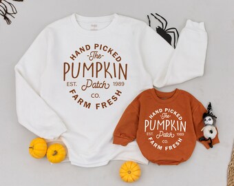 May include: Two white sweatshirts with brown text that reads "Hand Picked -The- Pumpkin Patch Est. 1989 Co. Farm Fresh". The smaller sweatshirt is orange.