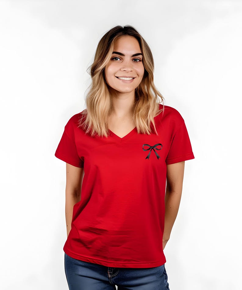 May include: A red v-neck t-shirt with a black bow on the front.