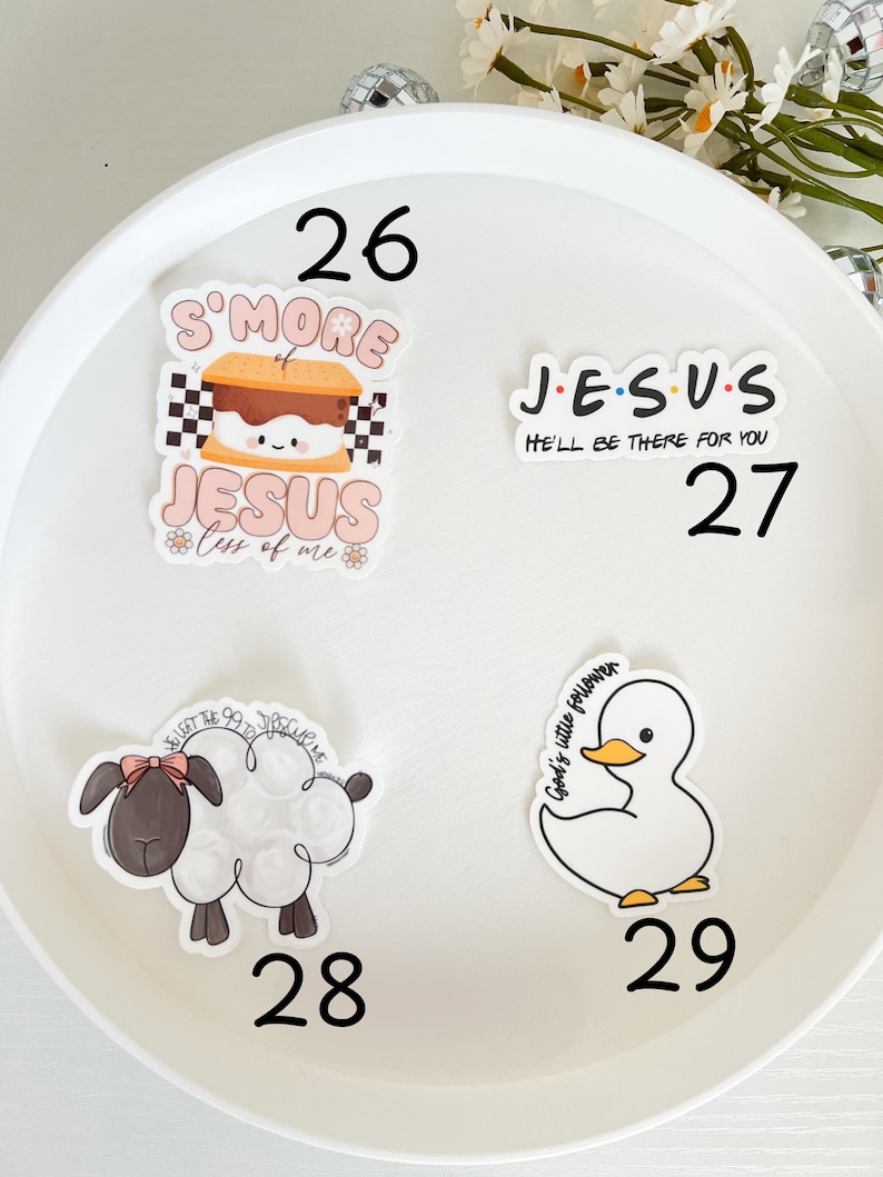May include: Four stickers on a white background. The stickers are round and feature various designs. One sticker features a s'more with the text "S'more Jesus" and "Less of me". Another sticker features the text "J.E.S.U.S." with the text "He'll be there for you". The third sticker features a white duck with the text "God's little follower". The fourth sticker features a white sheep with a pink bow and the text "You left the 99 to follow me".