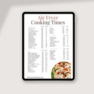 May include: A white tablet screen displaying a chart of air fryer cooking times for various foods, including vegetables, meat, and seafood. The chart lists the food, temperature, and time. The bottom of the screen shows a photo of a plate of food with a white background.