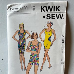 May include: A vintage Kwik Sew sewing pattern, number 2109, featuring illustrations of three different swimsuits. The pattern includes sizes XS-S-M-L. The swimsuits are in various styles and colors, including a yellow and blue design.