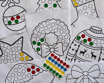 May include: A set of Christmas-themed dot-to-dot activity sheets featuring a Christmas tree, stocking, wreath, sweater, star, Santa hat, and gift box. Each sheet has a black and white outline of the image with circles for the dots. A sheet of colorful dot stickers is also included.