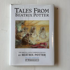 May include: A hardcover book titled "TALES FROM BEATRIX POTTER" with an illustration of mice. The cover is white with black text and a colorful illustration. The book is an original and authorized edition by Beatrix Potter.