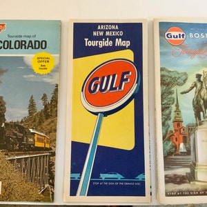 May include: Three vintage Tourguide maps from Conoco, Gulf, and Gulf Oil. The maps are for Colorado, Arizona and New Mexico, and Boston. The maps feature a train, a gas station sign, and a statue of Paul Revere.