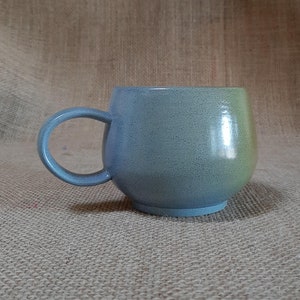 Handmade bluish/gray ceramic coffee cup.