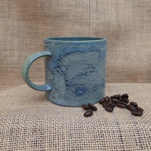 Handmade mottled rustic blue/green ceramic coffee cup.