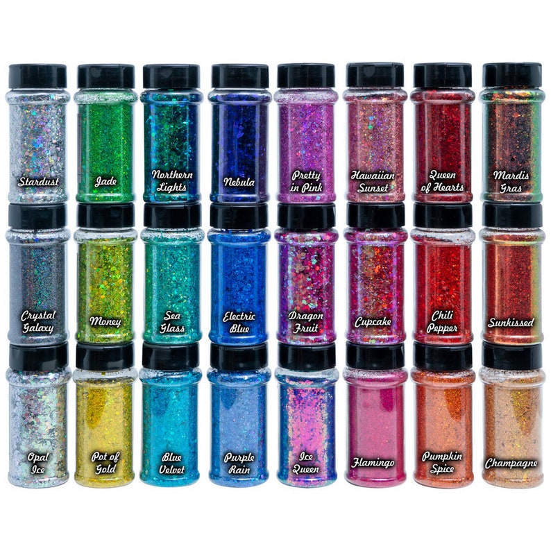 May include: Thirty-six small glass jars filled with iridescent glitter. Each jar has a black lid and a label with a different name, such as "Stardust", "Jade", "Northern Lights", and "Nebula".