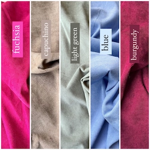May include: Five fabric swatches in fuchsia, capuchino, light green, blue, and burgundy. Each swatch has a ribbed texture and a label with the colour name. The fabrics are arranged vertically, showcasing a variety of colours.