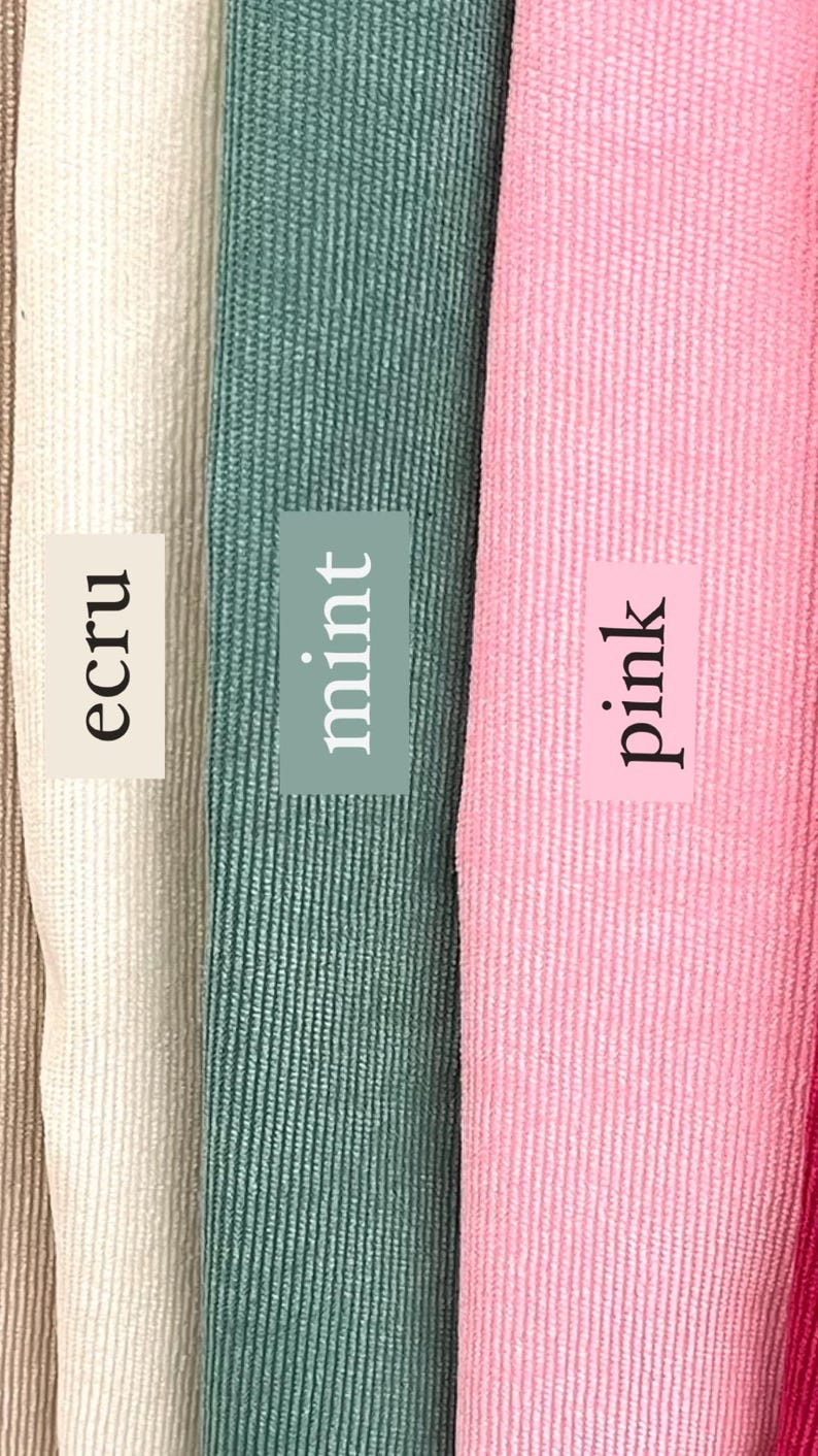 May include: Close-up of four fabric swatches in different colors: ecru, mint, pink, and red. The swatches are arranged side-by-side and have a textured, ribbed surface.