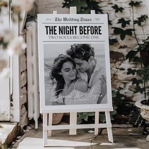 May include: Black and white wedding announcement sign with a photo of a couple embracing. The sign reads "The Wedding Times" and "The Night Before Two Souls Become One" with the couple's names "Ezekiel & Angela" at the bottom.
