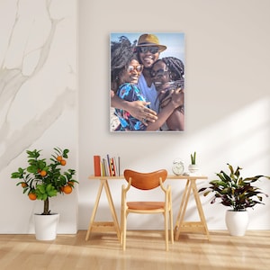 May include: A group of three people, two women and one man, are hugging each other. The man is wearing a hat and sunglasses. The women are also wearing sunglasses. They are all smiling and appear to be happy.