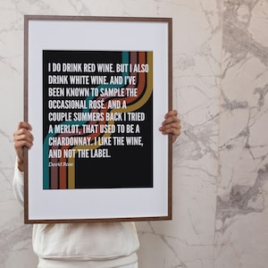 May include: A framed print with a black background and white text that reads "I do drink red wine. But I also drink white wine. And I've been known to sample the occasional rosé. And a couple summers back I tried a merlot, that used to be a chardonnay. I like the wine, and not the label." The text is surrounded by colorful stripes.
