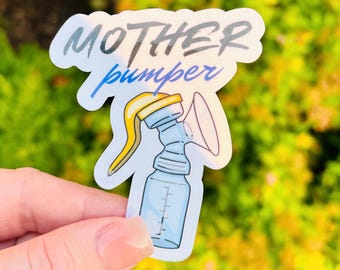 May include: A sticker featuring a blue and yellow breast pump illustration with the words "MOTHER pumper" in a handwritten font. The sticker is held by a hand against a blurred green and yellow background.