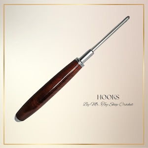 May include: A crochet hook with a polished, dark brown wooden handle and a silver metal shaft. The text "HOOKS" and "By Mr. Toy Shop Crochet" are displayed in the image.