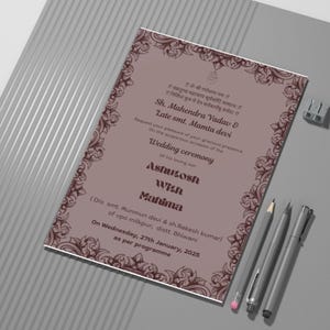 May include: A traditional Indian wedding invitation card with a brown and white floral design. The card features the names "Sh. Mahendra Yadav & Late smt. Mamta devi" and the text "Wedding ceremony of his loving son Ashutosh with Mahima". The invitation is for Wednesday, 27th January, 2025.