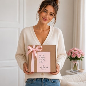 A woman holding a 30th birthday gift box for women filled with beauty treats, sweets, socks and birthday gifts