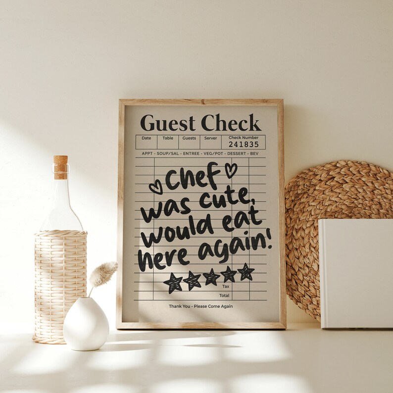 May include: A framed black and white guest check with a handwritten message that reads "Chef was cute, would eat here again!" with five stars below the message. The check number is 241835.