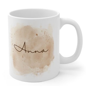 May include: White ceramic mug with a brown watercolor design and the name "Anna" in cursive script.