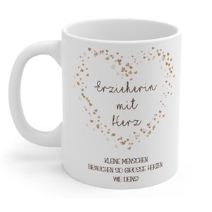 May include: White ceramic mug with a brown heart design and the text "Erzieherin mit Herz" and "Kleine Menschen brauchen so grosse Herzen wie Deins!"