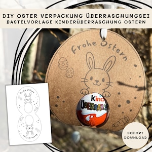 Könnte beinhalten: Ein braunes, eiförmiges Osterbastelprojekt mit einer Hasenillustration und den Worten "Frohe Ostern". Ein Kinder Überraschungsei befindet sich in der Mitte. Links ist ein weißes Papier mit Hasen- und Eierdesign.