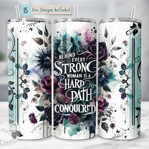May include: A white tumbler with a floral design and the text "Behind Every Strong Woman Is A Hard Path Conquered." The design includes dark purple roses, teal watercolor accents, and black accents. A straw is visible.