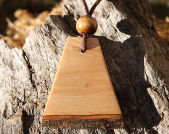 May include: A wooden triangle pendant with a brown cord and a wooden bead. The pendant has a natural wood finish and a dark brown edge.