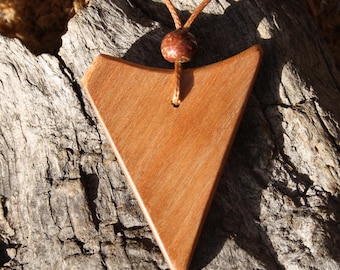May include: A wooden triangle pendant necklace with a brown leather cord and a brown wooden bead. The pendant is a light brown color and has a smooth finish.