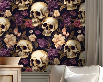 May include: Wallpaper featuring a repeating pattern of skulls and flowers in shades of cream, purple, and peach against a dark background. The skulls are detailed with shadows, and the flowers add a touch of softness to the design. The wallpaper is displayed in a room setting.