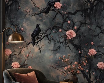 May include: A dark charcoal velvet armchair with a mauve pillow, positioned before wallpaper featuring black tree branches, pink roses, and two black crows. A brass floor lamp, a small brass side table with a vase, and a mauve ottoman are present.