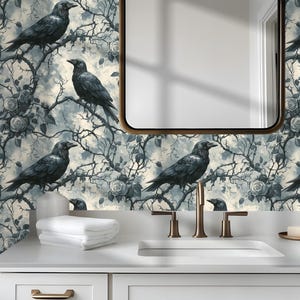 May include: A bathroom with a white vanity, a mirror, and a patterned wallpaper featuring black crows perched on branches with roses. The wallpaper has a gray and cream color scheme, creating a gothic or vintage aesthetic.