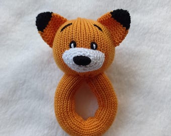 Puede incluir: Sonajero de bebé de punto naranja con forma de zorro, con orejas negras y cara blanca.