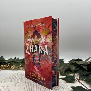 May include: A red, orange, and yellow fantasy book cover with a woman with long dark hair and a red dress holding a glowing flower. The title of the book is "ZHARA" and the author is "S. JAE-JONES".