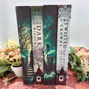 May include: Three fantasy novels with dark green, blue, and white covers. The titles are "One Dark Window", "Two Twisted Crowns", and "The Shepherd King". The books are by Rachel Gillig and published by Orbit.