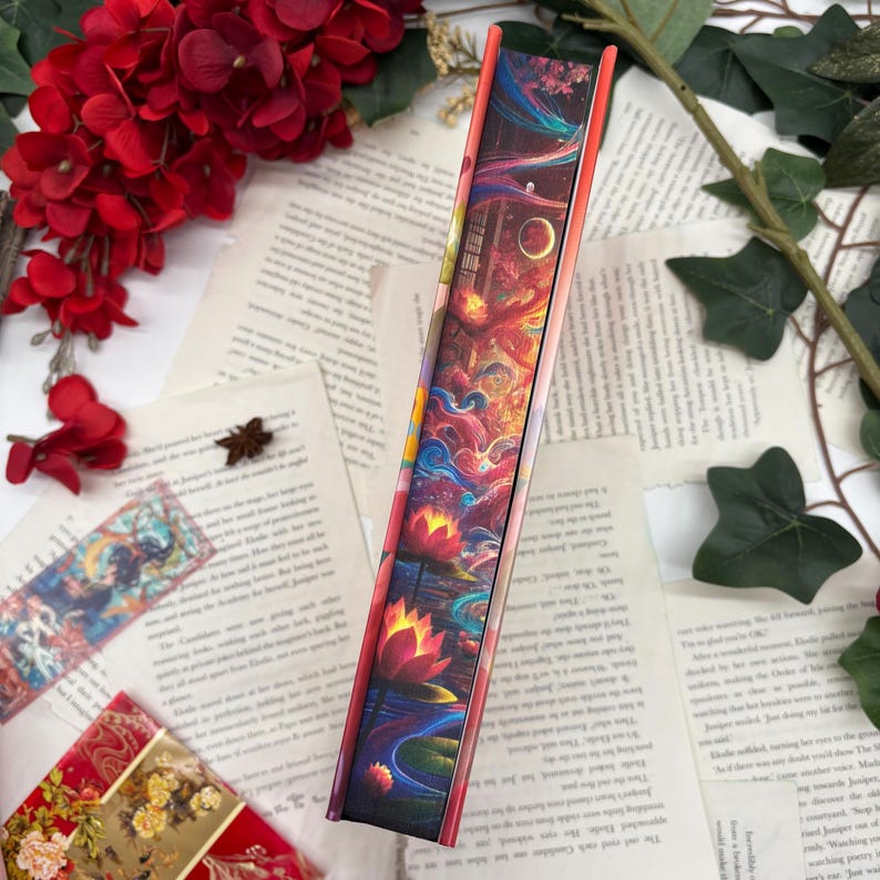 May include: A colorful book with a vibrant cover featuring a fantasy scene with flowers, clouds, and a starry sky. The book is bound in a hard cover with a textured finish.