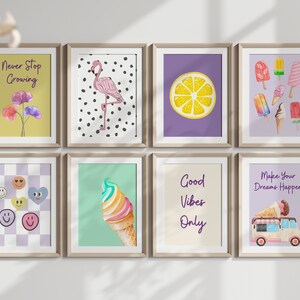 May include: Eight framed prints with various designs, including a flamingo on a black and white polka dot background, a lemon slice on a purple background, ice cream cones on a green background, and motivational quotes like "Never Stop Growing" and "Good Vibes Only".