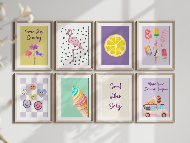 May include: Eight framed prints with various designs, including a flamingo on a black and white polka dot background, a lemon slice on a purple background, ice cream cones on a green background, and motivational quotes like "Never Stop Growing" and "Good Vibes Only".