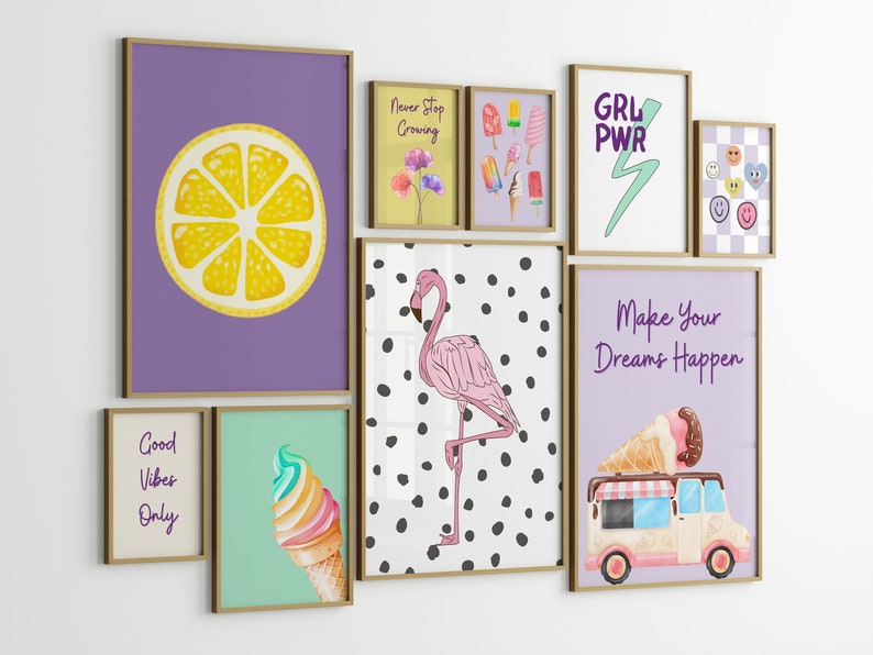 May include: A gallery wall of framed prints with various designs, including a lemon slice, a flamingo, ice cream cones, and inspirational quotes like "Good Vibes Only" and "Make Your Dreams Happen".