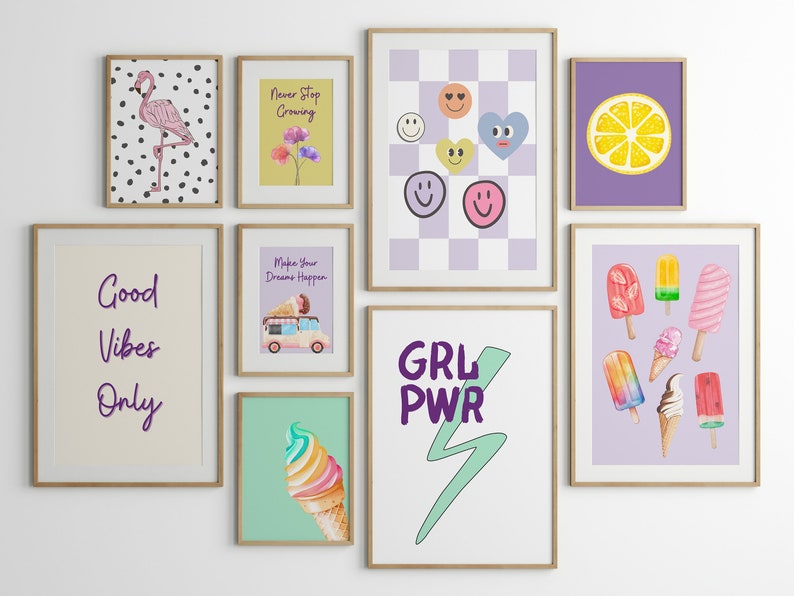 May include: A gallery wall of nine framed prints with various designs. The prints include a pink flamingo on a black and white polka dot background, a yellow background with flowers and the text "Never Stop Growing", a purple background with a checkered pattern and smiley faces, a purple background with a lemon slice, a cream background with the text "Good Vibes Only", a purple background with a ice cream truck and the text "Make Your Dreams Happen", a green background with a rainbow ice cream cone, a white background with the text "GRL PWR" and a green lightning bolt, and a purple background with various ice cream pops and cones.