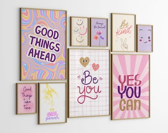 May include: A collection of eight framed prints with motivational quotes and illustrations. The prints feature a variety of colors, including pink, purple, blue, and yellow. The quotes include "Good Things Ahead", "Be Kind", "Be You", "Yes You Can", "Always Be Yourself", "Good Things Take Time", and "Girl Power".