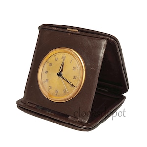 1930s A folding travel alarm clock in a leather case