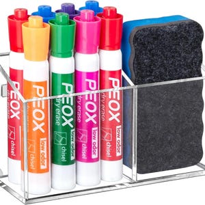 May include: A clear acrylic organizer with six dry-erase markers and a black eraser. The markers are labeled "PEOX dry erase low odor chisel".