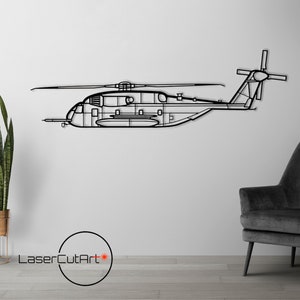 May include: Black metal helicopter wall art. The artwork depicts a detailed outline of a helicopter, showcasing its rotors, fuselage, and tail. The piece is mounted on a white wall, with a modern chair and lamp in the background.