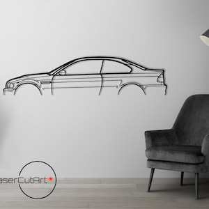 May include: Black metal wall art of a car silhouette. The car is a coupe with a sleek design. The art is mounted on a white wall with a black chair and a floor lamp in the background.