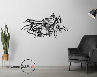 以下が含まれることがあります： 白い壁に描かれた、黒と白の線画のオートバイのイラスト。オートバイは側面から見て、右向き。オートバイは白い壁にあり、背景には黒い椅子とフロアランプがある。