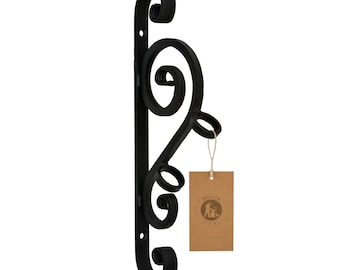 May include: Black metal wall mounted shelf with a decorative scroll design. The shelf has three round openings and a brown paper tag with the text "moria" and a logo.