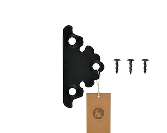 May include: Black metal corner bracket with a decorative design. It comes with three black screws.