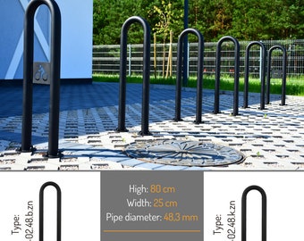May include: Black metal bike rack with a U-shaped design. The rack is 80 cm high, 25 cm wide, and has a pipe diameter of 48.3 mm. The rack can be installed by concreting or screwing it into the ground. The text "Type: B-02.48.b.zn" is printed on the left side of the rack and "Type: B-02.48.k.zn" is printed on the right side of the rack.