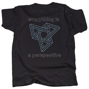 May include: Black t-shirt with a white graphic of an optical illusion triangle design and the text "everything is a perspective".