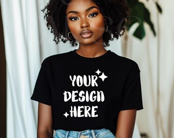 May include: A black t-shirt with the text "YOUR DESIGN HERE" in white lettering. The shirt is being worn by a person with dark curly hair.